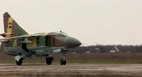 Fighter MiG-23 (NATO: Flogger) moves along  runway. Close-up. Syrian Air Force. Stock Footage 143460981