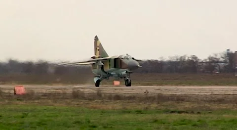 Fighter MiG-23 (NATO: Flogger) moves along  runway. Close-up. Syrian Air Force. Stock Footage 143461047
