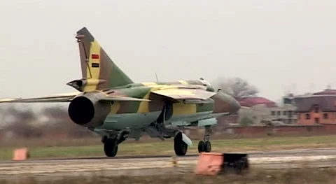 Fighter MiG-23 (NATO: Flogger) moves along  runway. Close-up. Syrian Air Force. Stock Footage 143461061