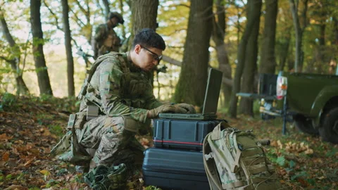 Fighter in military uniform using laptop computer for drone controlling Stock Footage 241005583