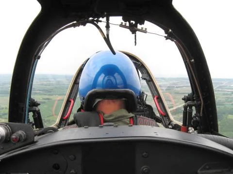 Fighter pilot flying in cockpit Stock Photos