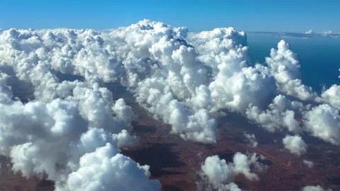 Fighter Pilot POV Flying Over Tiny Cumulus Clouds Hanging in a Blue Sky, Over a Stock Footage 321746112