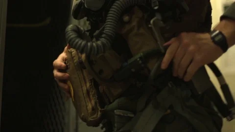 Fighter pilot securing flying clothing kit Stock Footage 102833408