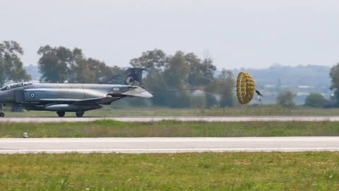 Fighter plane lands by opening the parachute in the tail to slow down Video stock 154988424
