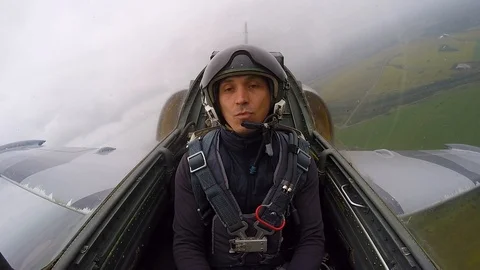 Fighter plane make barrel roll. Man dreaming that shoots from a machine gun. Stock Footage 118677957