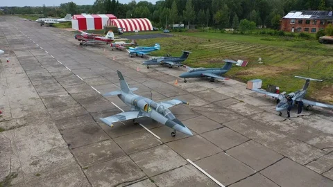 Fighter plane moves toward Landing Signal Officer and stops. Top view from drone Stock Footage 118676445