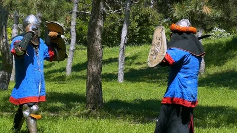 Fighter in plate armor makes a strike in jump and conducts a series of punches w Stock-Footage 122079838