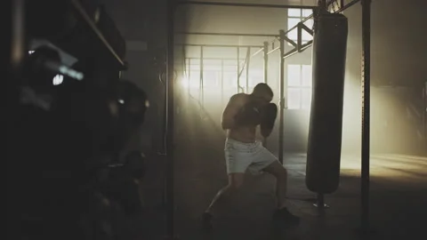 Fighter practicing with punching bag 스톡 동영상 236192844