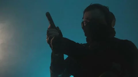 The fighter reloads the gun. Blue background. Front view. Stock Footage 229314800