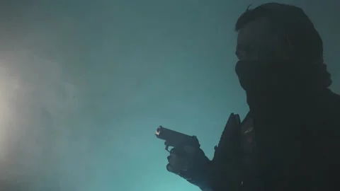 The fighter reloads the gun. Blue background. Side view. Stock Footage 229314860