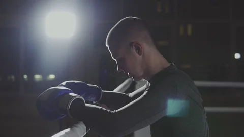Fighter resting on ropes of ring. Kickboxer training in smoky studio Video stock 109792071