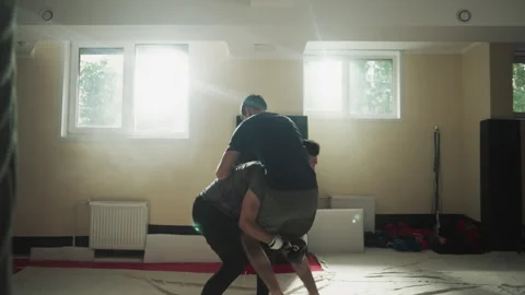 Fighter throws partner punching on club floor Stock Footage 256962126