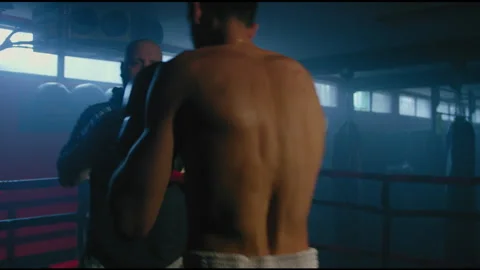 Fighter training with couch in ring Stock Footage 275089314