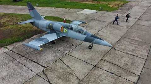 Fighter training plane move on runway at the old airfield. Top view of drone. Stock Footage 118676113