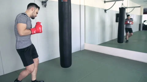 Fighter Trains With Punching Bag In The Gym Stock Footage 64330910
