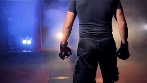 A fighter walking closer to a red cage. Stock Footage 80927795