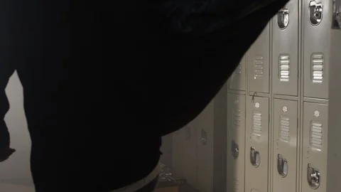 Fighter walks into gym changing room with big dufffle bag 動画素材 104531670