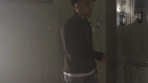 Fighter walks into gym locker room and opens locker getting ready to train 스톡 동영상 104535316