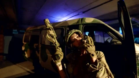 A fighter with a weapon in a tactical helmet, eyes closed,   動画素材 301303694