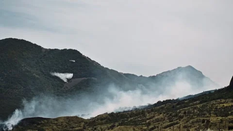 Fighting a forest fire in the mountains with helicopters. The feat of Stock Footage 291103989