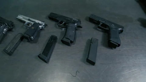 Fighting guns with a holder on an iron table Stock Footage 60189601