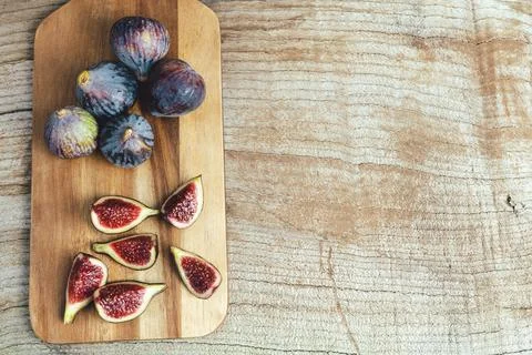Figs cut on kitchen table. Copy space. Stock Photos