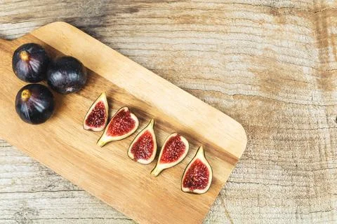 Figs cut on kitchen table. Copy space. Stock Photos