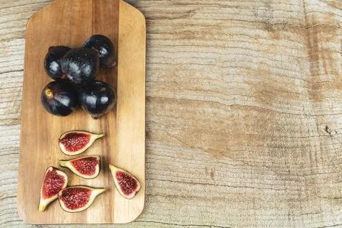 Figs cut on kitchen table. Copy space. Stock Photos