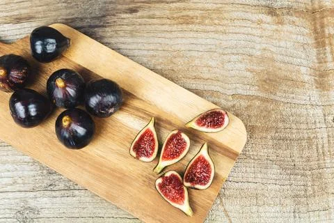 Figs cut on kitchen table. Copy space. Stock Photos