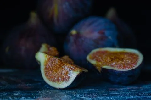 Figs on a dark wood background. selective focus on the figs slice Stock Photos