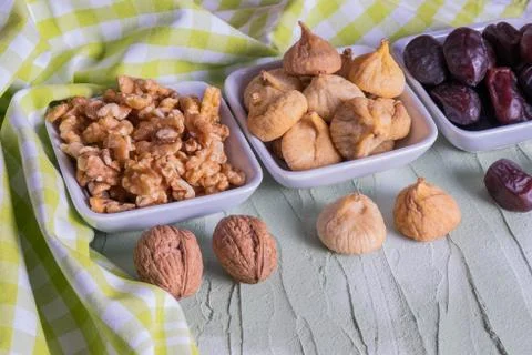 Figs, nuts and dates are on the table. Stock Photos