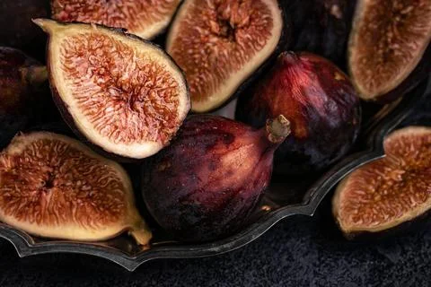 Figs in a silver dish on the table. Close up. Stock Photos