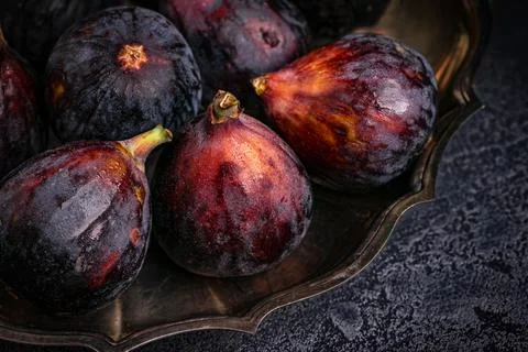 Figs in a silver dish on the table. Close up. Stock Photos