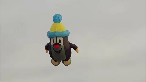 Figurative mole kite flying in front of cloudy sky Video stock 70824028