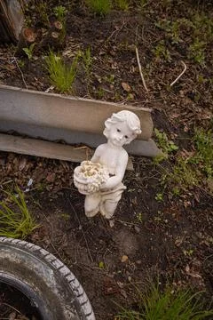 Figure of an angel on a garden plot Stock Photos