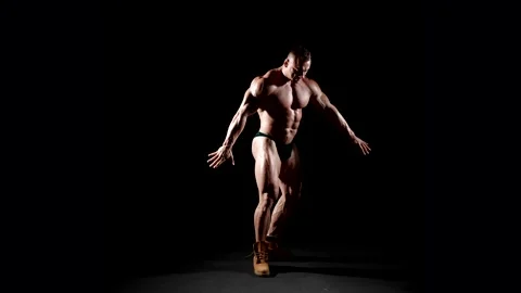 The figure of a bodybuilder in a classic pose with his arms raised.  Stock Footage 300889806
