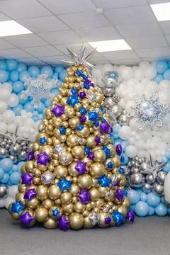 The figure of a Christmas tree made of balloons. The symbol of the new 2022 Stock Photos