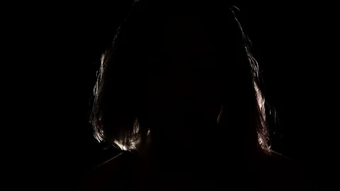 Figure in the dark with back light outlining its hair 스톡 동영상 122357068