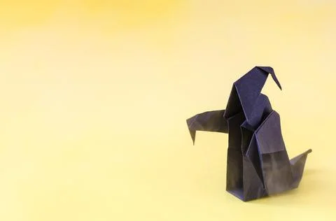 The figure of a dark ghost on a yellow background is a place for text. Stock Photos
