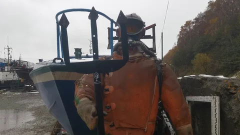 A figure in a diving suit with a Trident. Stock Footage 117569326