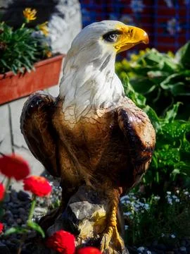 Figure of eagle made of stone. Stuffed bird of prey. Background Stock Photos