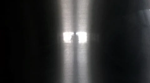 Figure emerging from the light in a dream-like corridor Video stock 53307786