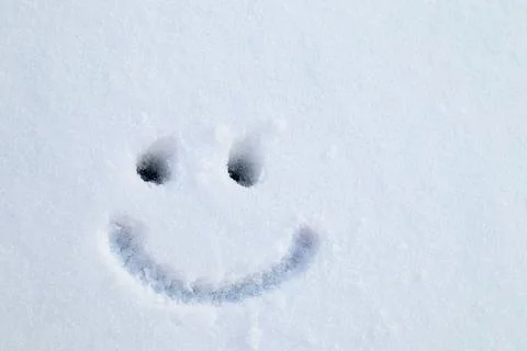 Figure face drawn on the snow, smile and eyes, emotions. Postcard Stock Photos