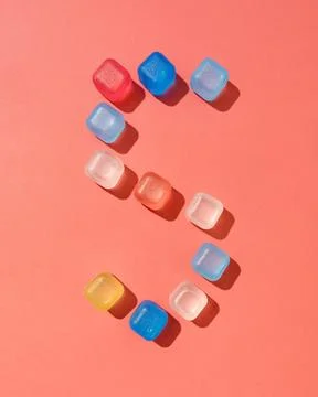 Figure five pattern from colored plastic ice cubes on a background in a col.. Stock Photos