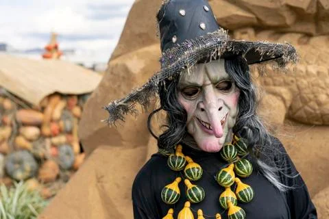 Figure of a gray-haired witch with pumpkin beads. Stock Photos