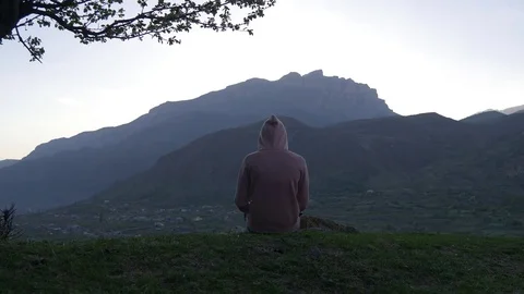 Figure in a jacket with a hood in the mountains Video stock 75495640