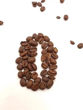 A figure made of coffee beans on a light background Stock Photos