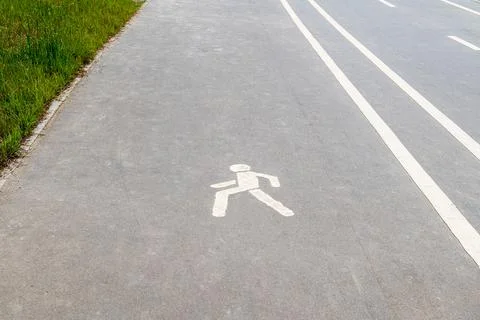 Figure of a man on a pedestrian path Stock Photos