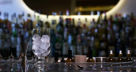 Figure of professional bartender appears in a bar to prepare a negroni alcoholic Stock Footage 106468847