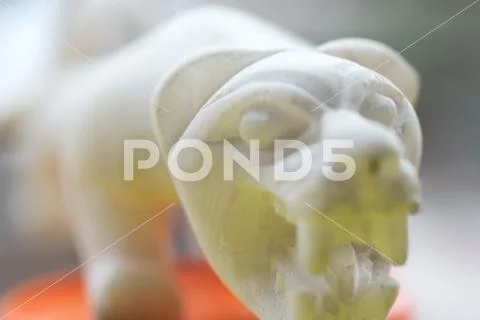 Figure of a Puma carved in white marble. The puma is one of the sacred animal Stock Photos